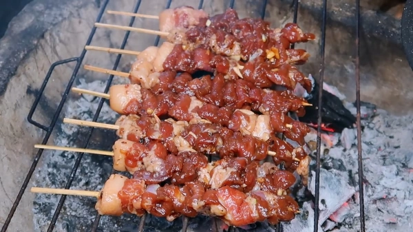 pork BBQ on grill with hot coal behind